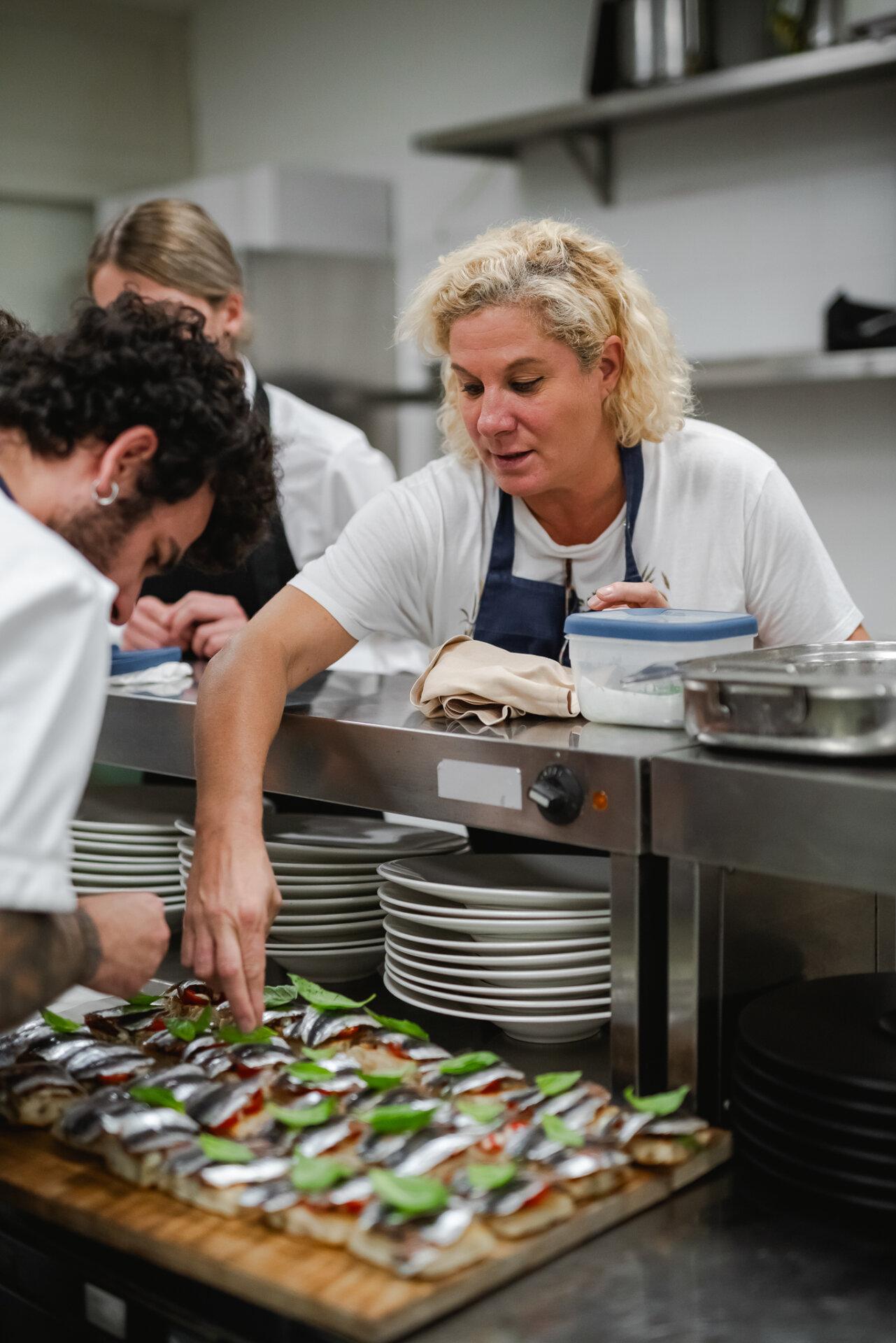 Ana Roš in the kitchen and a plate of bruschettas