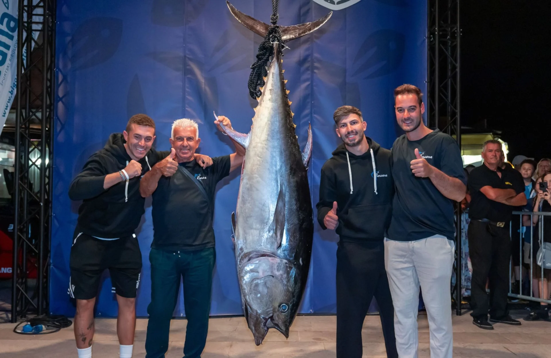 Four members of a fishing team pose beside a large tuna during a Tunalicious Festival weigh-in in Poreč.