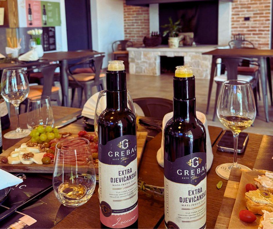 Table with two bottles of olive oil and typical Istrian food Table with two bottles of olive oil and typical Istrian food