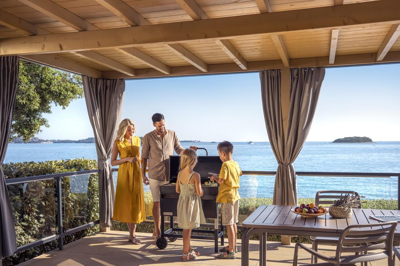 Family near a barbeque on a camping home terrace