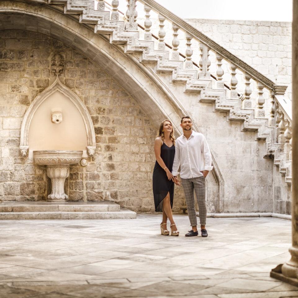 Couple marvelling at the Rector’s palace, centrally located in Dubrovnik’s Old Town