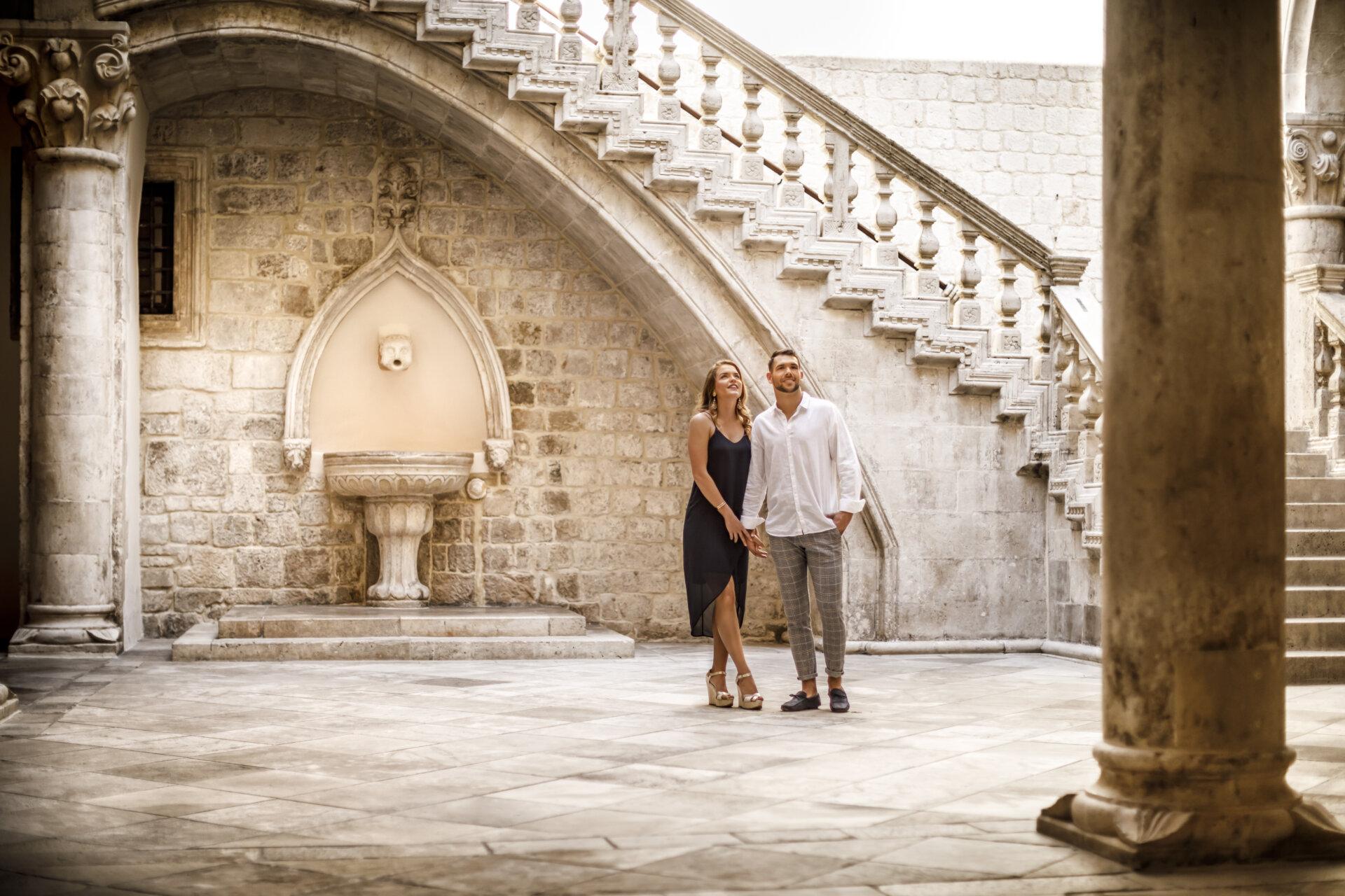 Couple marvelling at the Rector’s palace, centrally located in Dubrovnik’s Old Town