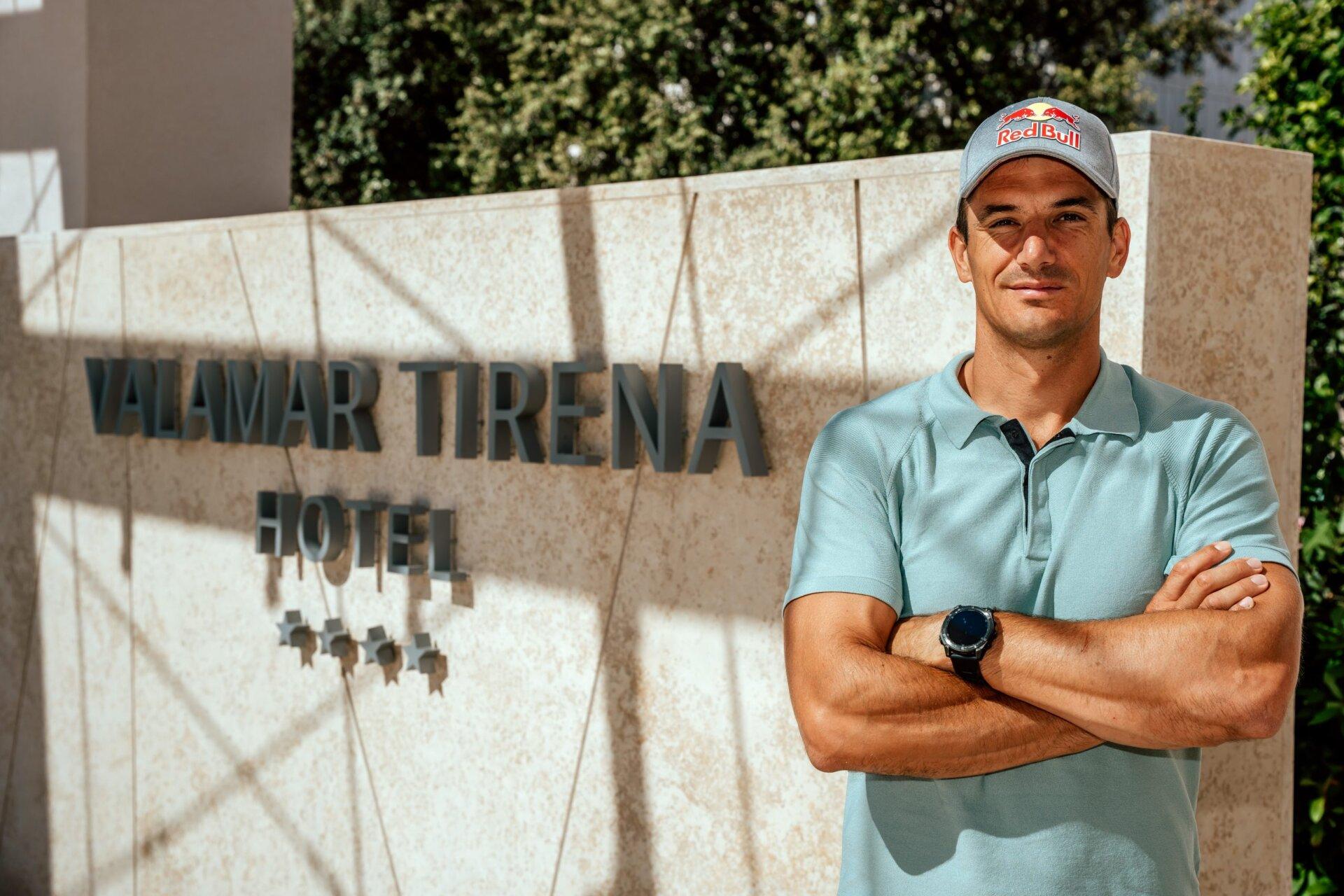 A man in a light blue polo shirt standing with arms crossed in front of the Valamar Tirena Hotel sign.