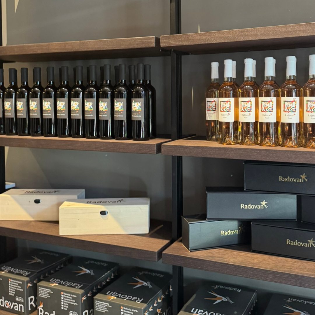 Shelves displaying Radovan Wines bottles and elegant gift boxes inside the winery shop.