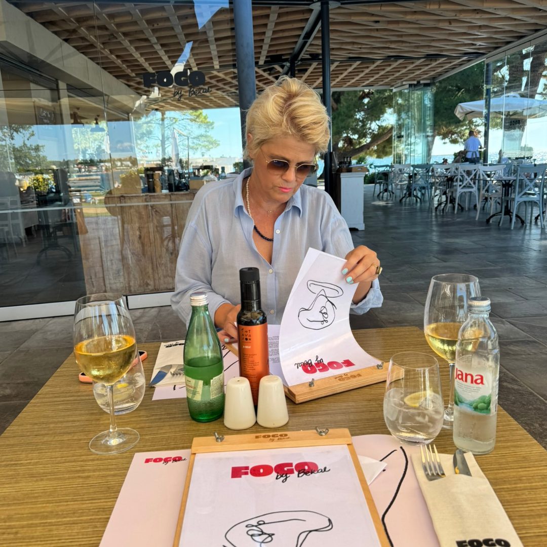 A woman in the Fogo by Bekal restaurant is having a look at the menu.