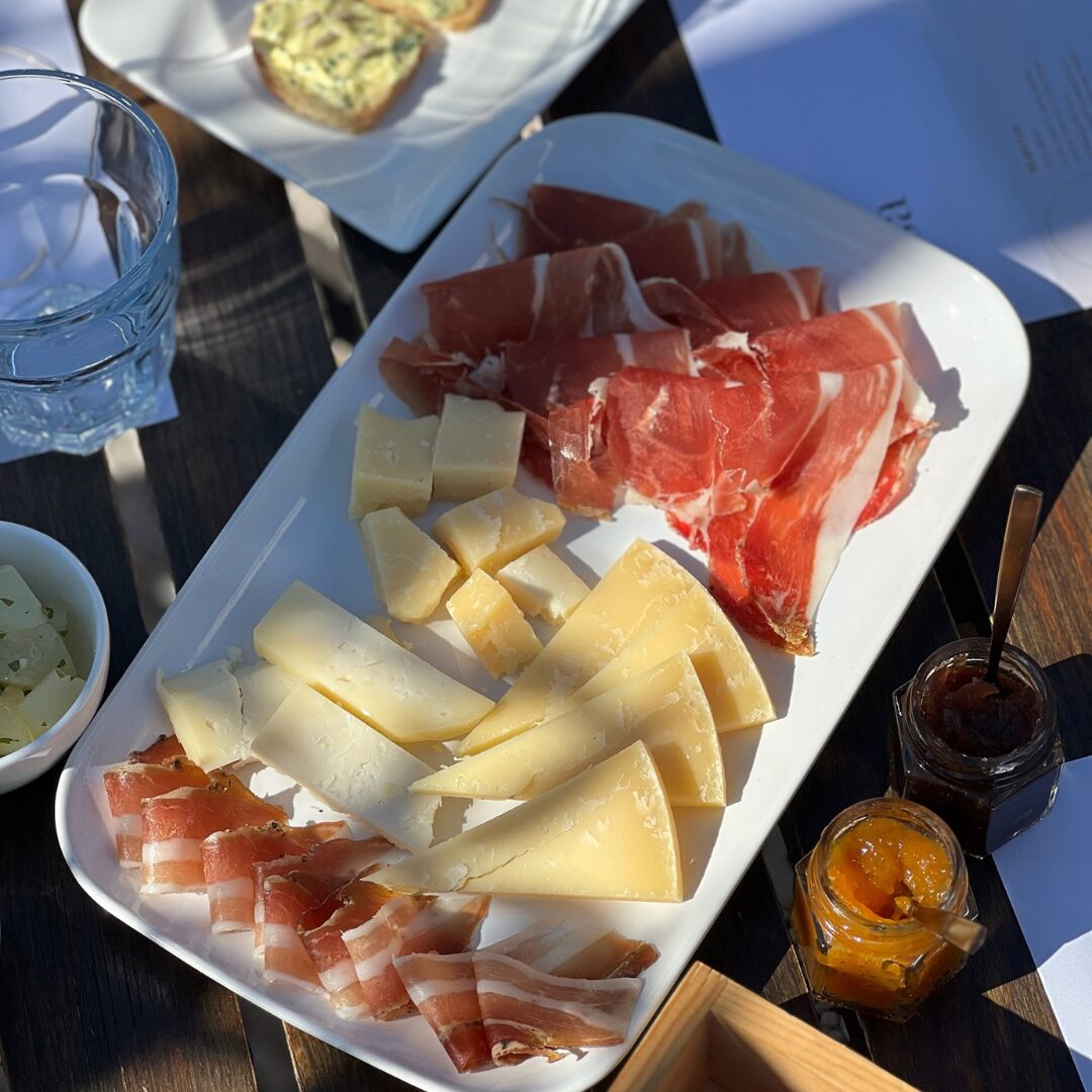 Platter of Istrian prosciutto, pancetta, and cheeses with onion and kumquat marmalades.
