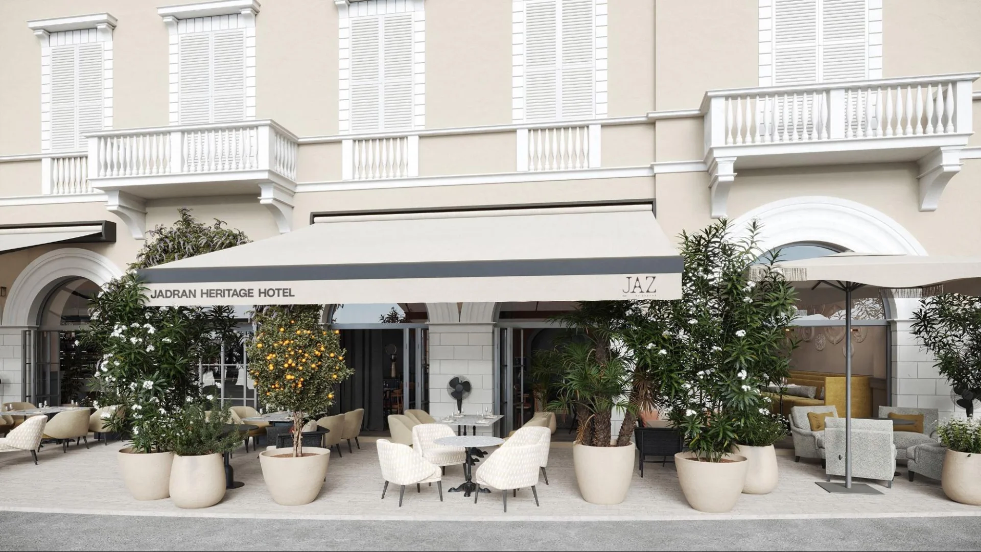 Elegantno pročelje hotela i moderna vanjska terasa restorana JAZ by Ana Ro&scaron; uz ulicu, ukra&scaron;ena biljkama.