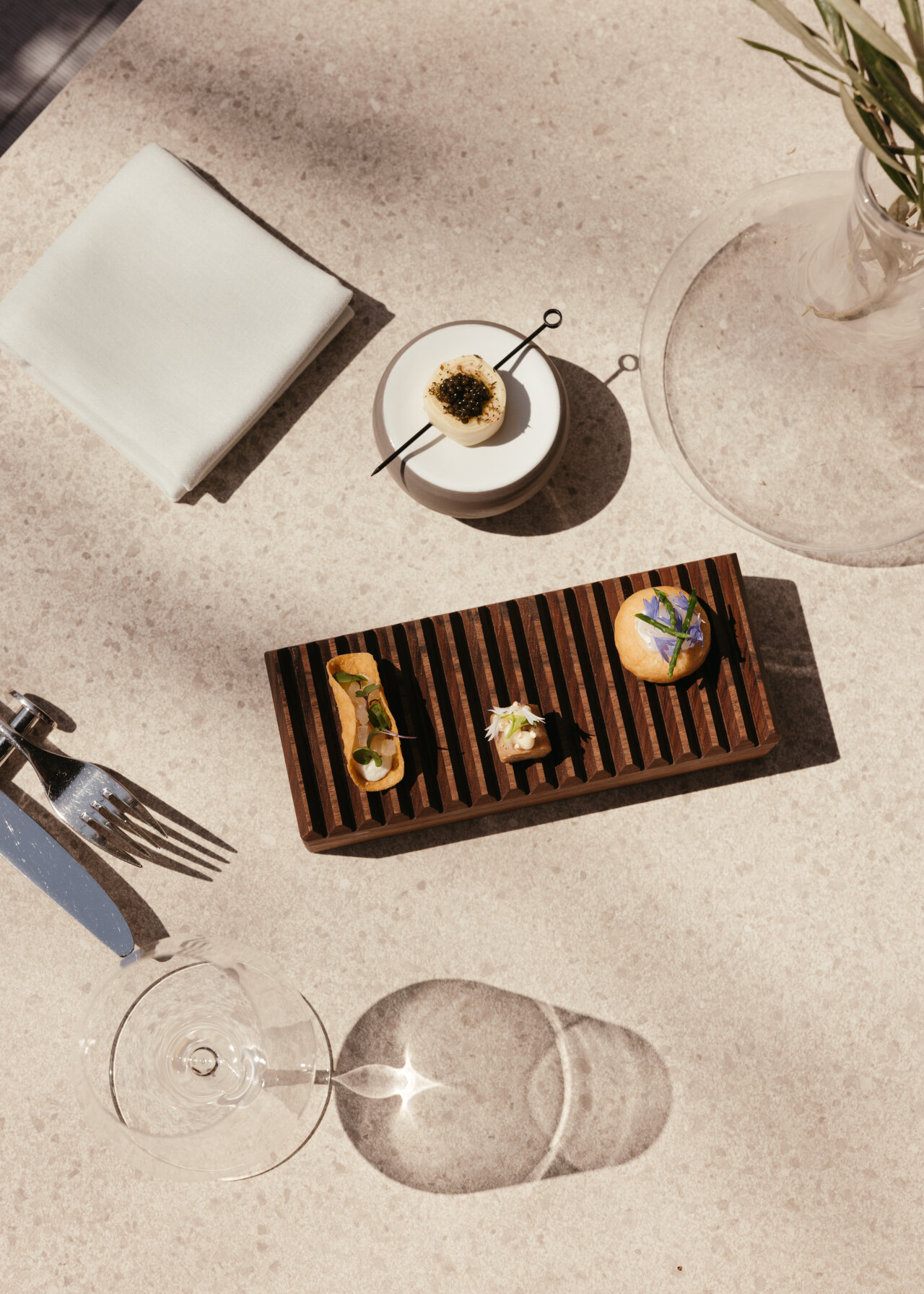 Gourmet bite-sized appetisers served on a wooden tray at Spinnaker restaurant.