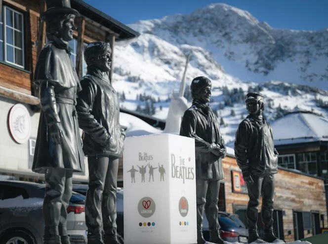 Life-sized statue of The Beatles in front of Hotel Edelweiss in the valley, perfect for a souvenir photo.
