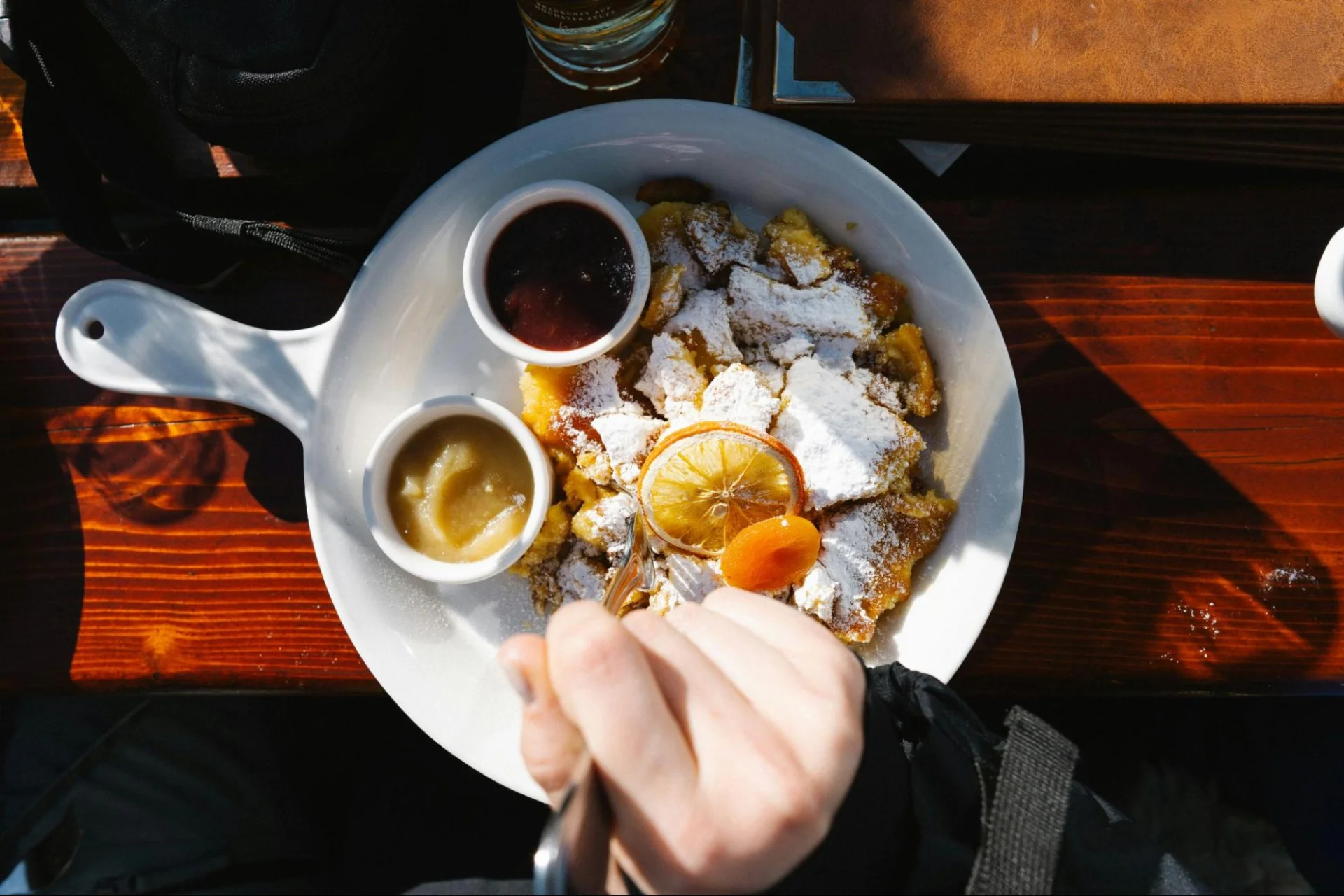 A plate of delicious Kaiserschmarrn served with applesauce and plum compote.