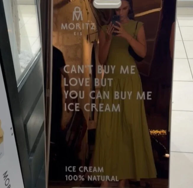 A mirror inside Moritz Eis featuring a message about natural ice cream in Dubrovnik.