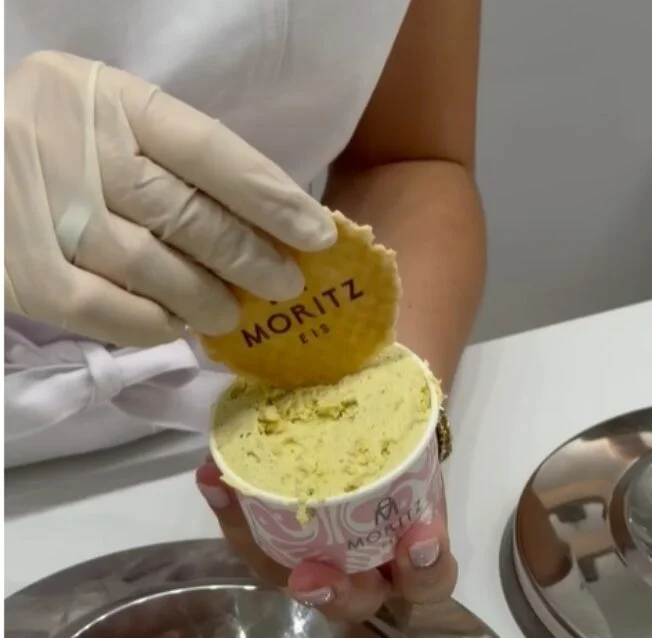 Creamy ice cream topped with a decorative Moritz biscuit and served in a cup at a Dubrovnik ice cream parlour.