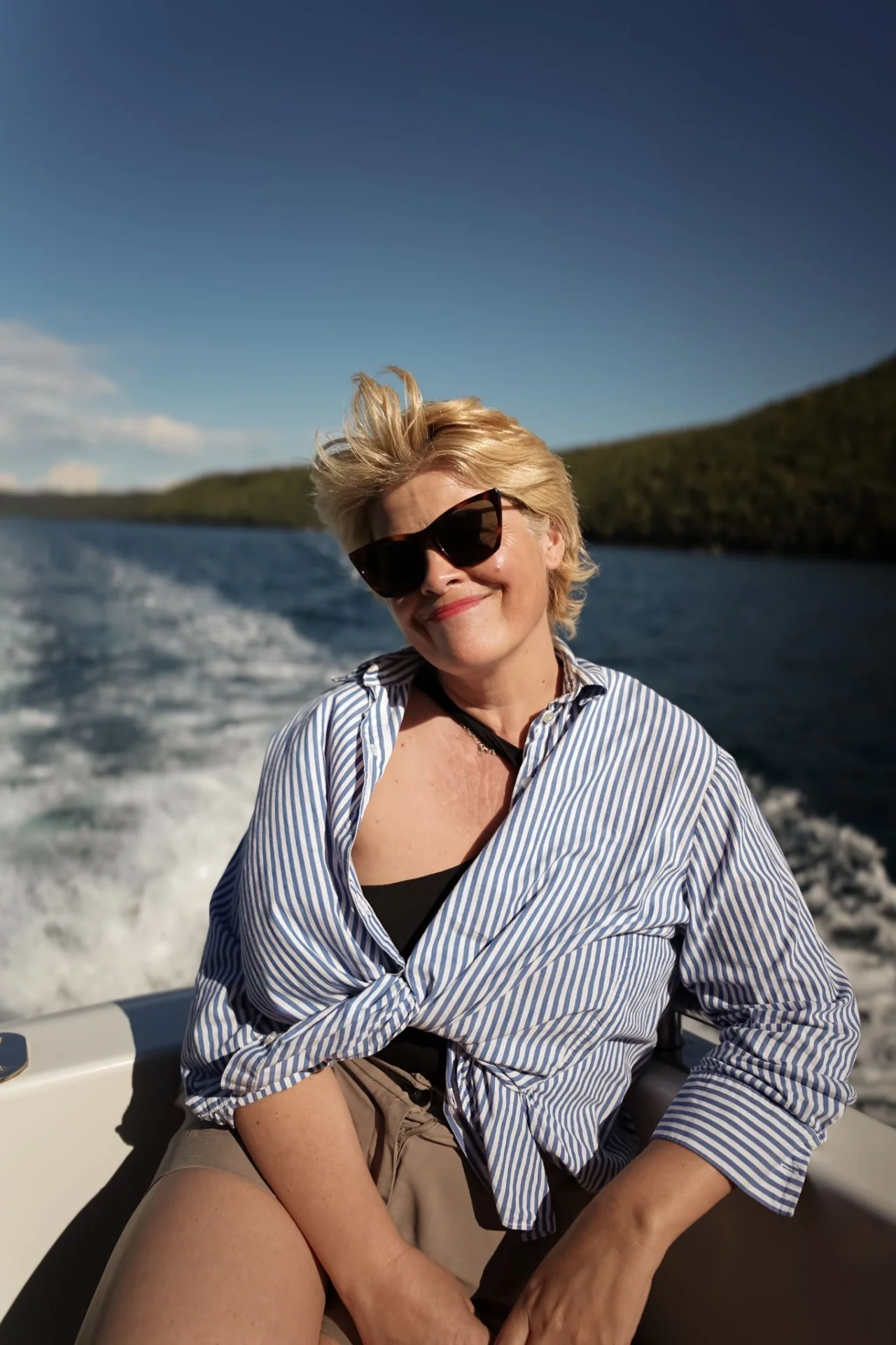 A relaxed boat ride through the Lim Bay with views of the sea and green coastline.