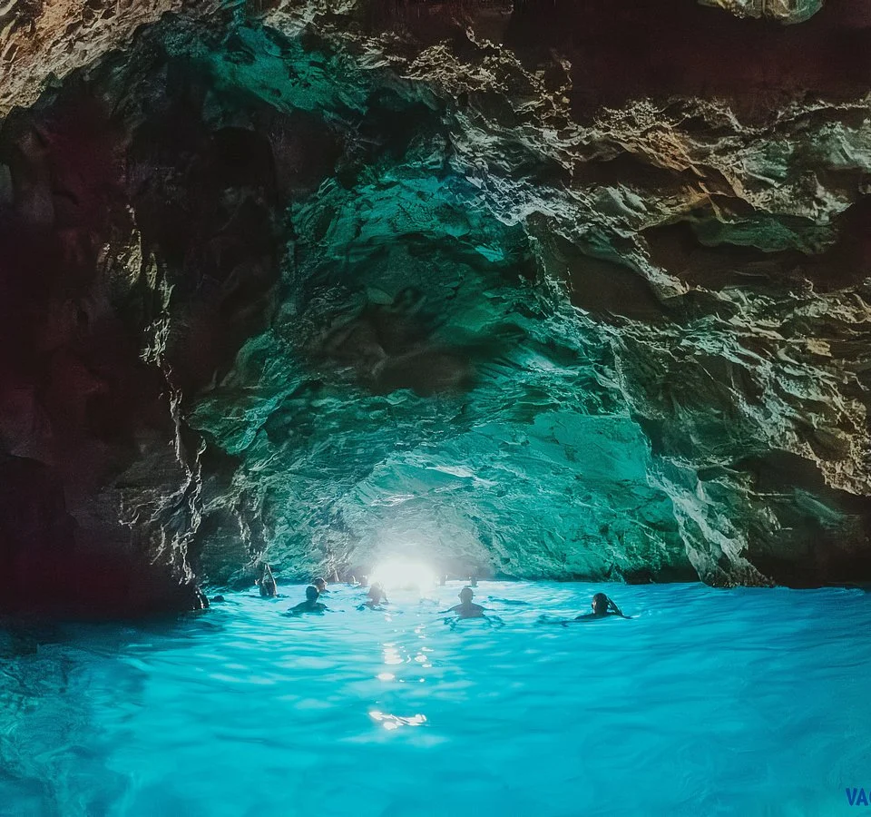 People swimming in the Blue Cave