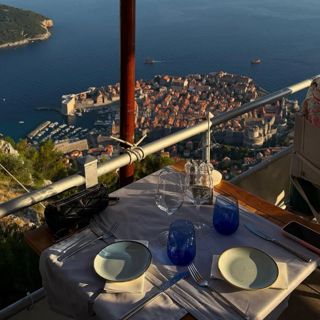 Set table at Panorama Restaurant on Mount Srđ overlooking Dubrovnik Old Town and the Adriatic Sea.
