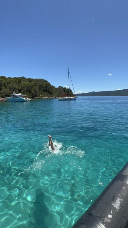 Collage showing a swimmer jumping into turquoise sea, snorkelling equipment on board, and a boat approaching a cove.