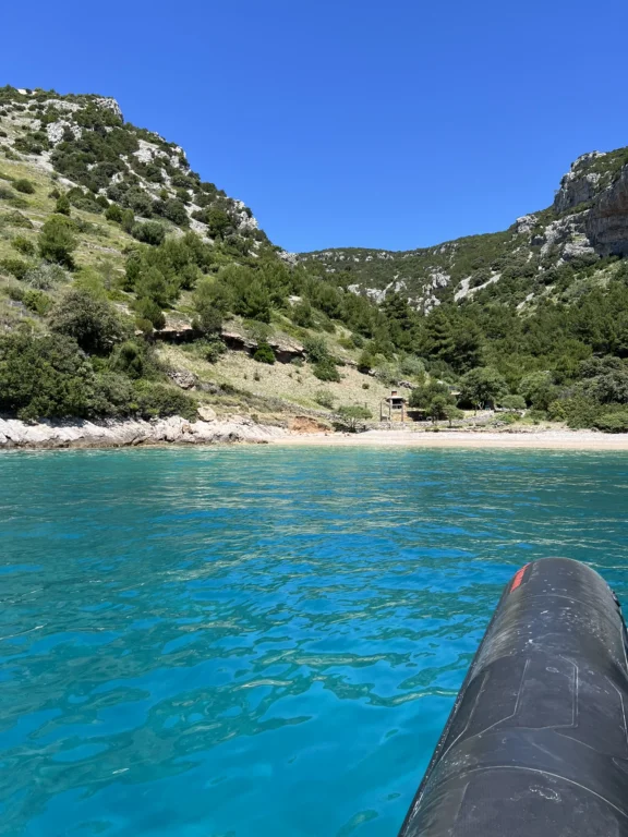 Collage showing a swimmer jumping into turquoise sea, snorkelling equipment on board, and a boat approaching a cove.