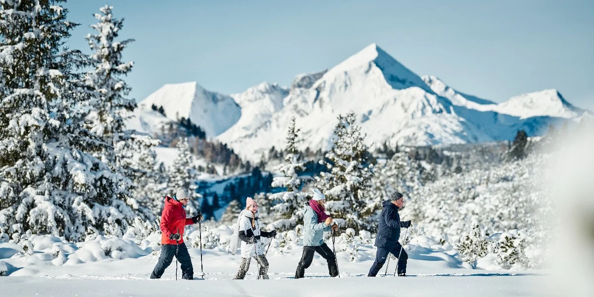 Visitors enjoying a snowshoeing adventure in Obertauern, Austria.
