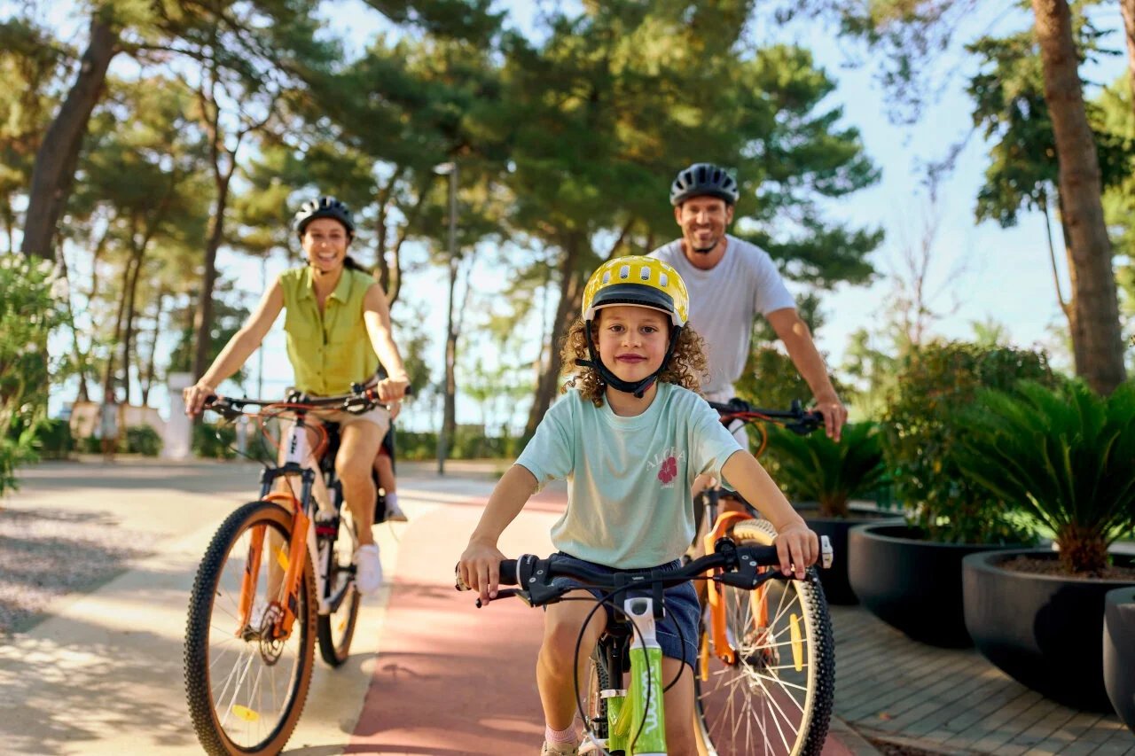 Family cycling together at Pical Resort in Poreč.
