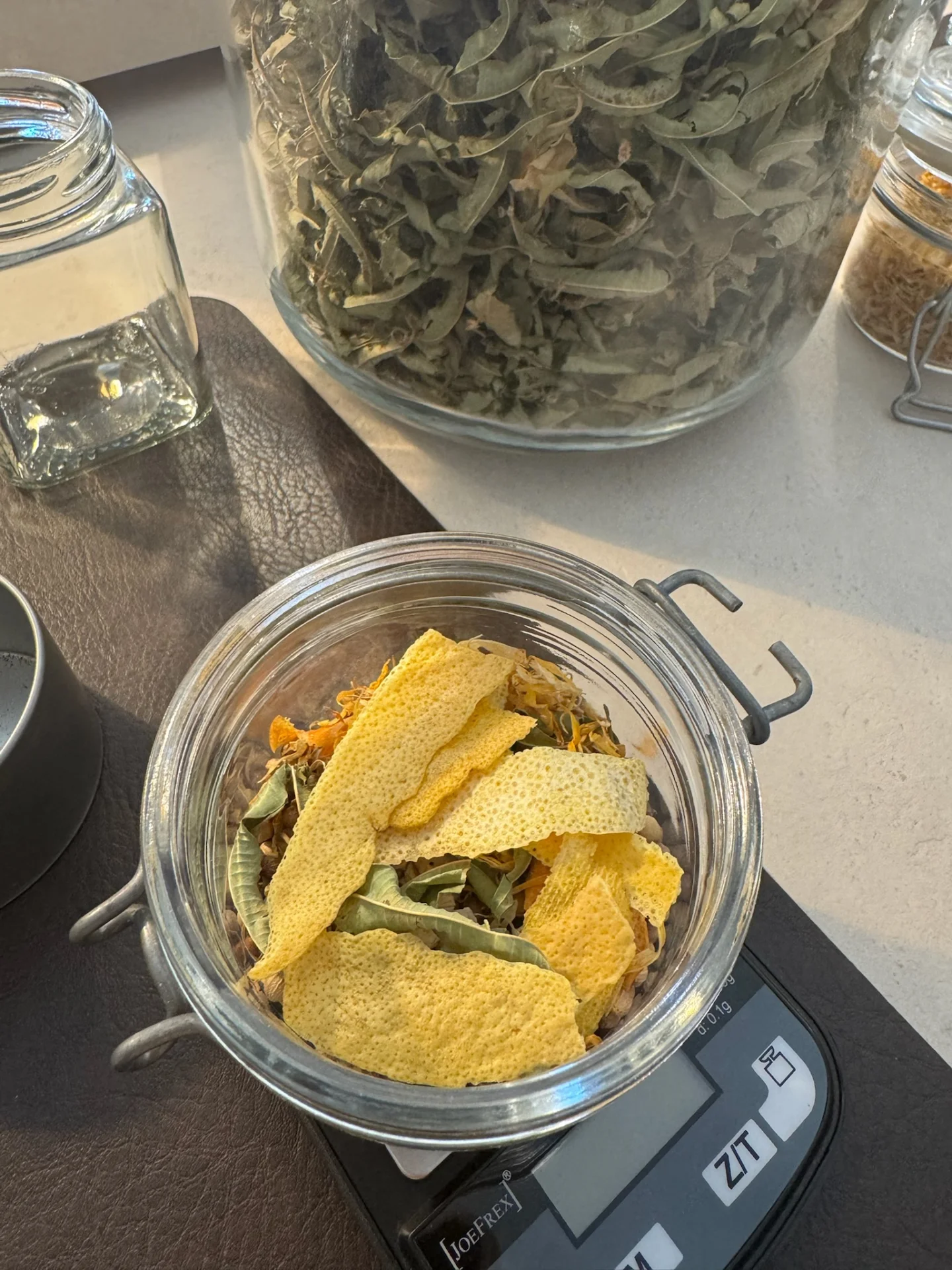 Selected herbs and citrus botanicals weighed for a personalised gin recipe.