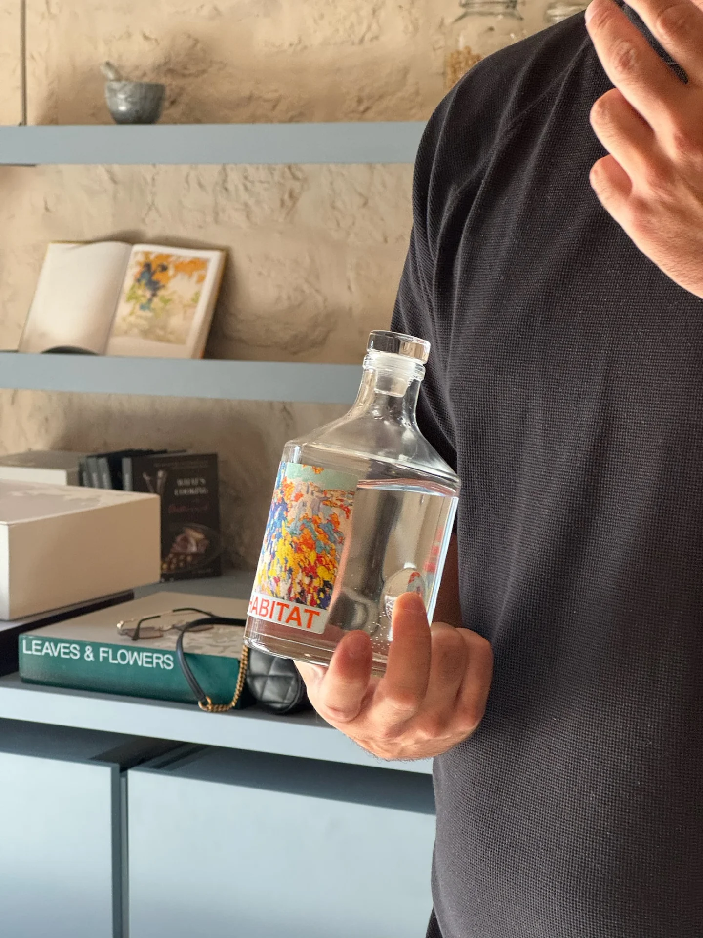 Master distiller presenting a bottle of gin during the workshop at Habitat Distillery.