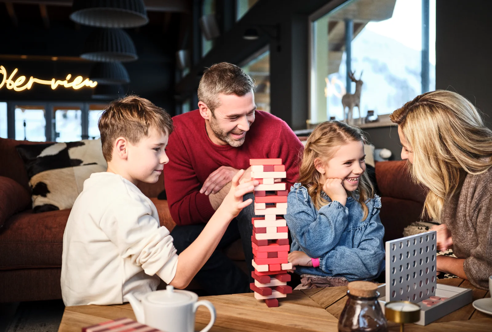 Family playing a board game together during a winter holiday in Obertauern
