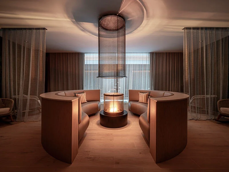 Relaxation area with a central fireplace at ESPA at Pical.
