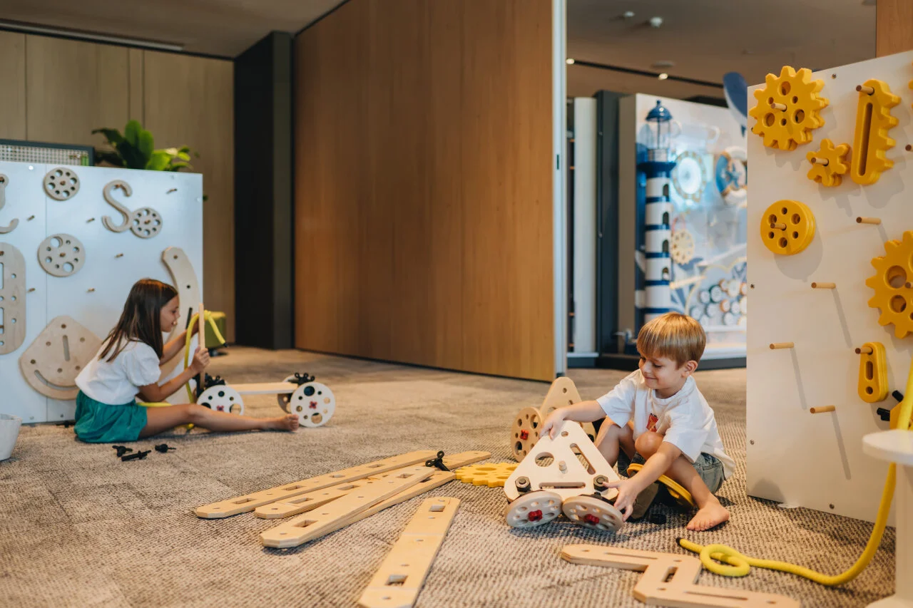 Children playing with educational toys and a climbing structure in the children’s playroom at Pical Resort.