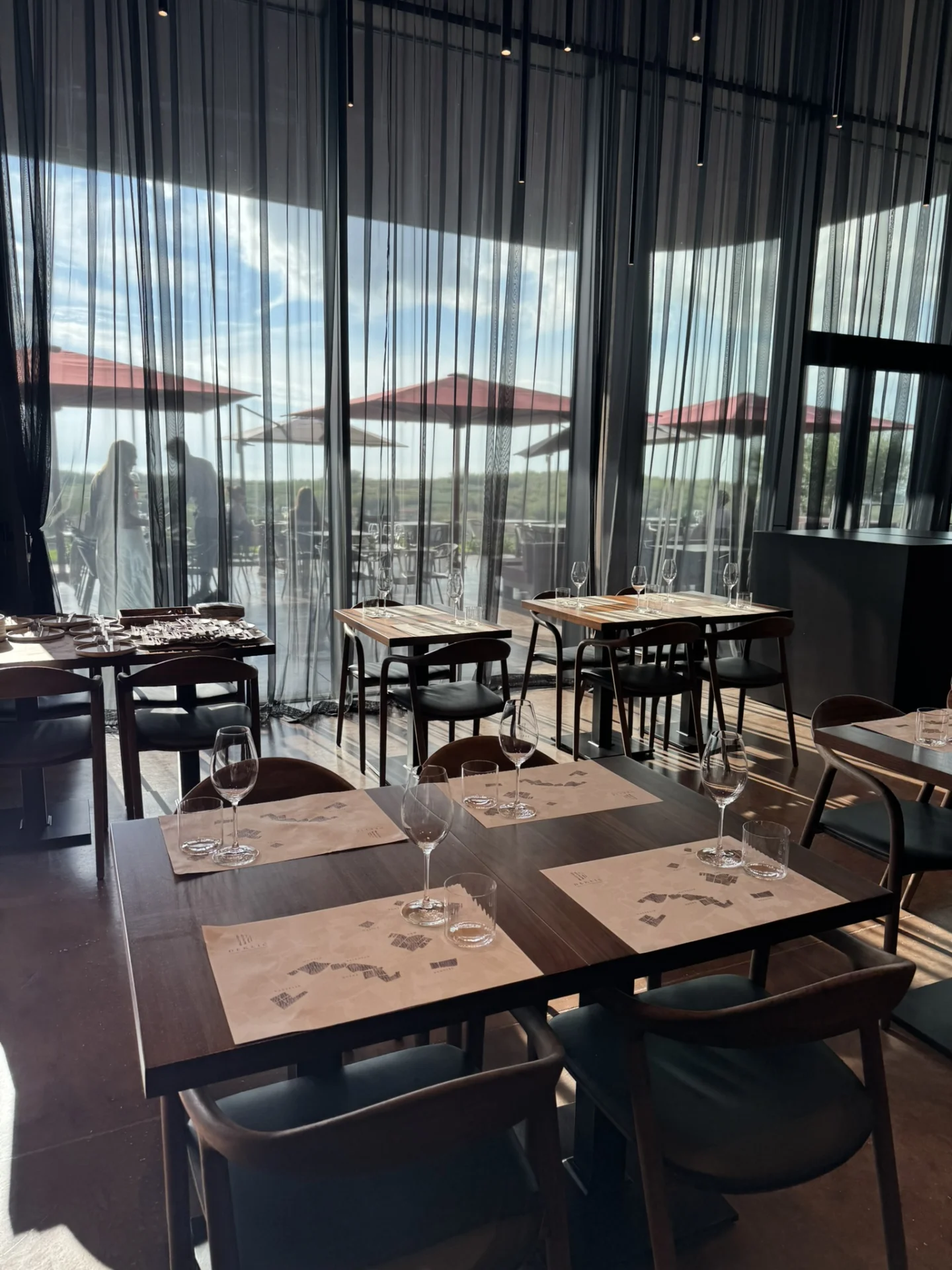 Elegant wine tasting room at Deklić Winery in Istria, featuring modern furnishings, large windows and vineyard views.