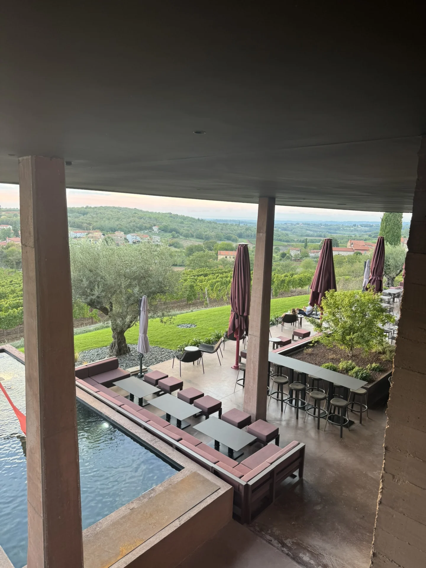 Panoramic outdoor terrace at Deklić Winery, featuring modern seating, large parasols and beautiful views of the surrounding Istrian countryside.