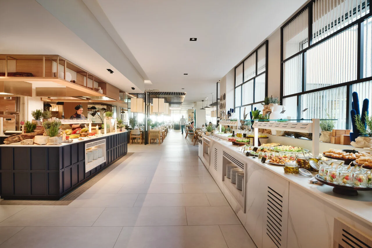 Spacious, contemporary buffet restaurant at Pical Resort 5*, offering a wide selection of dishes and views of the surrounding greenery.
