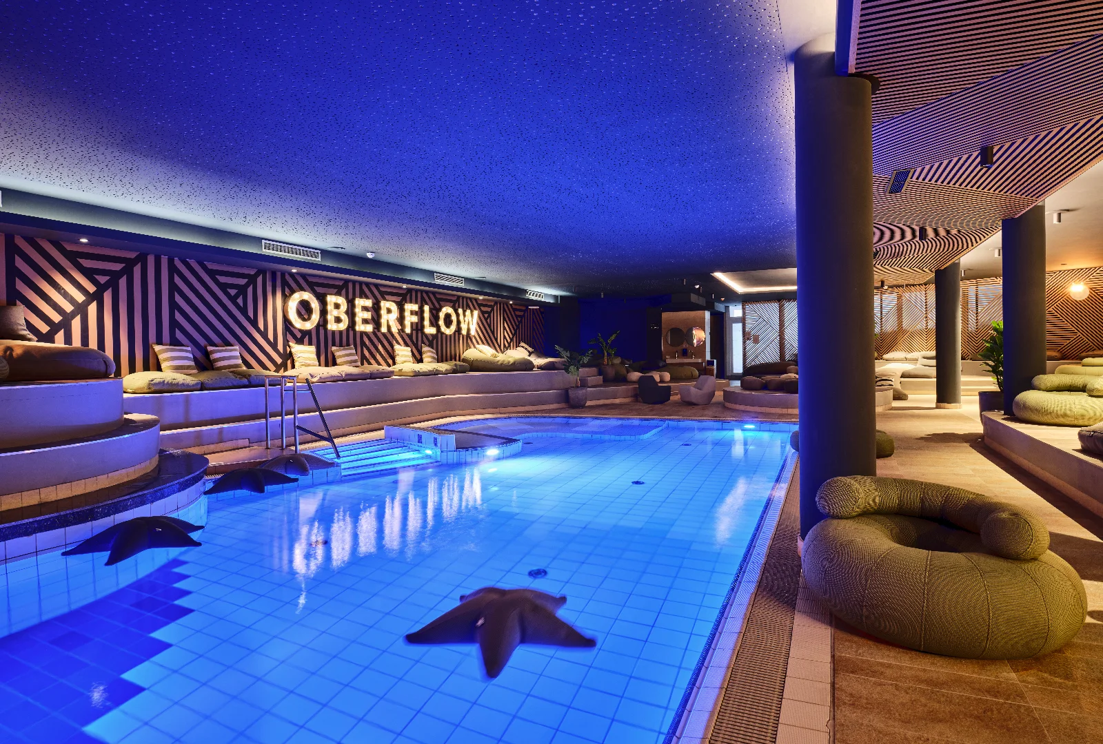 Indoor pool at [PLACES] Obertauern by Valamar with a sundeck and relaxation area.