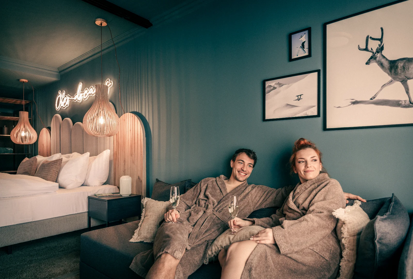 A couple enjoying a stay in a modern guest room at [PLACES] Obertauern by Valamar, featuring contemporary Alpine-inspired design.&nbsp;