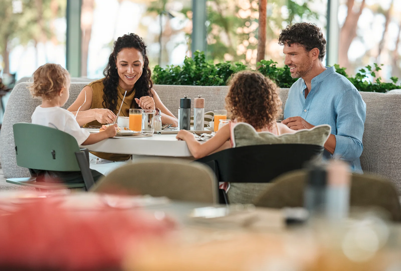 A family enjoying a meal together at a hotel restaurant.