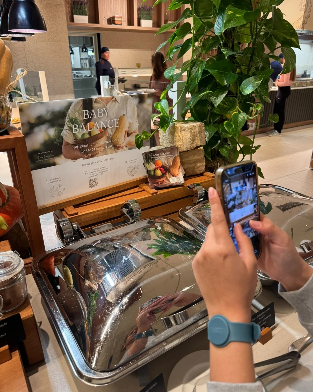 A parent scanning a QR code on a mobile phone to check the ingredients and allergens in a child’s meal.